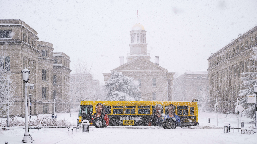 cambus in heavy snow in front of Old Capitol