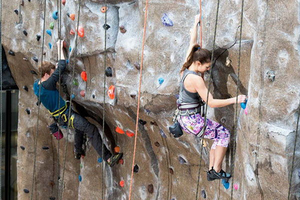 Adults on indoor climbing wall